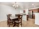 Kitchen and dining area with hardwood floors and modern chandelier at 18907 N Vemto St, Maricopa, AZ 85138