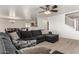 Spacious living room with L-shaped sofa and tile flooring at 18907 N Vemto St, Maricopa, AZ 85138