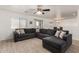 L-shaped sectional sofa and tile flooring in living room at 18907 N Vemto St, Maricopa, AZ 85138