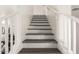 Modern staircase with wood steps and white railings at 18907 N Vemto St, Maricopa, AZ 85138