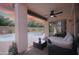 Covered back patio offering a comfortable outdoor living space with a view of the pool and landscaped yard at 2073 E Wildhorse Dr, Chandler, AZ 85286