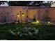 Enchanting backyard garden with beautiful flower arrangements and landscape lighting at 2073 E Wildhorse Dr, Chandler, AZ 85286