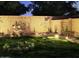 Enchanting backyard garden with beautiful flower arrangements and landscape lighting at 2073 E Wildhorse Dr, Chandler, AZ 85286