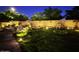 Backyard garden with pool, lush green grass and landscape lighting at 2073 E Wildhorse Dr, Chandler, AZ 85286