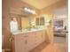 Bright bathroom featuring double sinks, modern fixtures, and a large mirror at 2073 E Wildhorse Dr, Chandler, AZ 85286