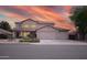 Two-story home features a three-car garage and desert landscaping against a beautiful sunset sky at 2073 E Wildhorse Dr, Chandler, AZ 85286