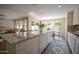 Bright kitchen features granite counters, a large island with seating, and views to the living room and backyard at 2073 E Wildhorse Dr, Chandler, AZ 85286