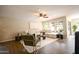 Bright living room featuring a large sectional sofa, neutral decor, and views of the backyard at 2073 E Wildhorse Dr, Chandler, AZ 85286