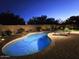 Beautiful backyard pool with brick patio, lounge chairs, and landscaping with accent lighting at 2073 E Wildhorse Dr, Chandler, AZ 85286