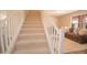 Bright staircase with carpeted steps and white railing leading to the second floor at 2073 E Wildhorse Dr, Chandler, AZ 85286