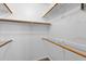Walk-in closet features neutral paint, carpeted flooring, and wooden closet rods and shelving at 2134 E Broadway Rd # 2033, Tempe, AZ 85282