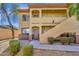 Tan condo building featuring private entrances, landscaped grounds, and a well-maintained exterior at 2134 E Broadway Rd # 2033, Tempe, AZ 85282