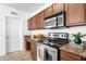 Modern kitchen with stainless steel appliances, granite countertops and wood cabinetry at 2134 E Broadway Rd # 2033, Tempe, AZ 85282