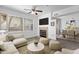 Cozy living room featuring a ceiling fan, fireplace, plush seating, and plenty of natural light at 2134 E Broadway Rd # 2033, Tempe, AZ 85282