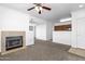 Open living room with a fireplace, neutral carpet, and a view into the updated kitchen at 2134 E Broadway Rd # 2033, Tempe, AZ 85282