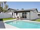 Sparkling swimming pool with a sun-soaked deck, surrounded by lush lawn, offering a relaxing outdoor oasis at 2217 N 79Th St, Scottsdale, AZ 85257