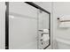 Bathroom featuring a tile shower with a dark-trimmed glass door and a shower head at 2217 N 79Th St, Scottsdale, AZ 85257