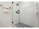 Tile shower featuring a glass door, sleek fixtures, and gray tile flooring at 2217 N 79Th St, Scottsdale, AZ 85257