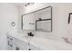 Elegant bathroom featuring a large mirror, white marble countertop and modern black fixtures at 2217 N 79Th St, Scottsdale, AZ 85257