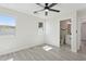 Bright bedroom features light gray floors and a doorway to the ensuite bathroom at 2217 N 79Th St, Scottsdale, AZ 85257
