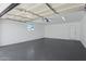 Spacious garage featuring ample lighting, fresh paint, and a convenient access door to the side of the house at 2217 N 79Th St, Scottsdale, AZ 85257