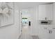 Bright hallway featuring modern cabinets, marble counters, and a view into a sunlit living area at 2217 N 79Th St, Scottsdale, AZ 85257