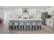 Stylish kitchen featuring white cabinets, a gray island with seating, and modern appliances at 2217 N 79Th St, Scottsdale, AZ 85257