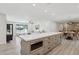 Open layout kitchen with an island with a microwave and granite countertops and sight to living room at 2217 N 79Th St, Scottsdale, AZ 85257
