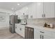 Updated kitchen features stainless steel appliances, white cabinetry and quartz countertops at 2217 N 79Th St, Scottsdale, AZ 85257