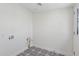 Bright laundry room with stylish patterned flooring, utility connections, and access door with plenty of space at 2217 N 79Th St, Scottsdale, AZ 85257