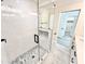 Stylish shower with a glass door, subway tile walls, a mosaic tile floor, and black fixtures at 2217 N 79Th St, Scottsdale, AZ 85257