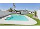 Refreshing swimming pool surrounded by a manicured lawn and a white concrete deck, perfect for outdoor enjoyment at 2217 N 79Th St, Scottsdale, AZ 85257
