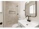 Updated bathroom with modern vanity, sleek mirror, and tiled shower with black trim at 2227 W Paradise Dr, Phoenix, AZ 85029