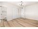 Clean bedroom with ample closet space, modern light fixtures, and wood-look flooring at 2227 W Paradise Dr, Phoenix, AZ 85029