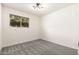 Vacant bedroom featuring a new carpet, window, and modern ceiling light at 2227 W Paradise Dr, Phoenix, AZ 85029