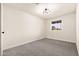 Neutral bedroom with new carpeting, natural light, and modern light fixture at 2227 W Paradise Dr, Phoenix, AZ 85029
