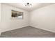Unfurnished room with neutral carpeting, a modern chandelier, and good natural light at 2227 W Paradise Dr, Phoenix, AZ 85029