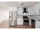 Bright kitchen featuring new stainless steel appliances and white cabinets, accented by modern hardware at 2227 W Paradise Dr, Phoenix, AZ 85029
