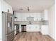 Updated kitchen featuring stainless steel appliances, white cabinets, and bright lighting at 2227 W Paradise Dr, Phoenix, AZ 85029