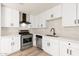 Beautiful kitchen featuring new stainless steel appliances, white cabinets, updated lighting and hardwood floors at 2227 W Paradise Dr, Phoenix, AZ 85029