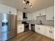 Bright kitchen features white cabinets, stainless steel appliances, and modern fixtures at 2227 W Paradise Dr, Phoenix, AZ 85029