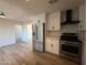 Open concept kitchen features stainless steel refrigerator and updated appliances at 2227 W Paradise Dr, Phoenix, AZ 85029