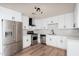 Modern kitchen with stainless steel appliances, white cabinets, new countertops, and wood-look flooring at 2227 W Paradise Dr, Phoenix, AZ 85029