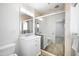 This bright bathroom features a glassed in shower and a sink with white cabinets at 2527 N 69Th Pl, Scottsdale, AZ 85257