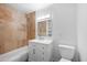Bathroom with a tiled shower-bath, vanity, lighting, and toilet at 2527 N 69Th Pl, Scottsdale, AZ 85257
