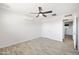 Bright bedroom features light wood floors, a white ceiling, and a door to the ensuite bath at 2527 N 69Th Pl, Scottsdale, AZ 85257