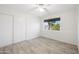 Neutral bedroom with a sliding door closet and a window view of the neighborhood at 2527 N 69Th Pl, Scottsdale, AZ 85257