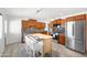Stylish kitchen features stainless steel appliances, a center island, and wood cabinets at 2527 N 69Th Pl, Scottsdale, AZ 85257