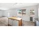 Bright kitchen with a center island, white cabinets and a view of the backyard at 2527 N 69Th Pl, Scottsdale, AZ 85257