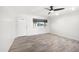 Bright living room featuring a ceiling fan, hardwood floors, and a large window at 2527 N 69Th Pl, Scottsdale, AZ 85257